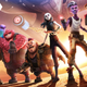 The animated alien crew of Star Trek Prodigy—Zero, Murf, Rok-Tahk, Jankom, Gwyn, and Dal,—joined by a holographic Captain Janeway all stand on an alien planet with the sun on their backs and their ship in the sky.